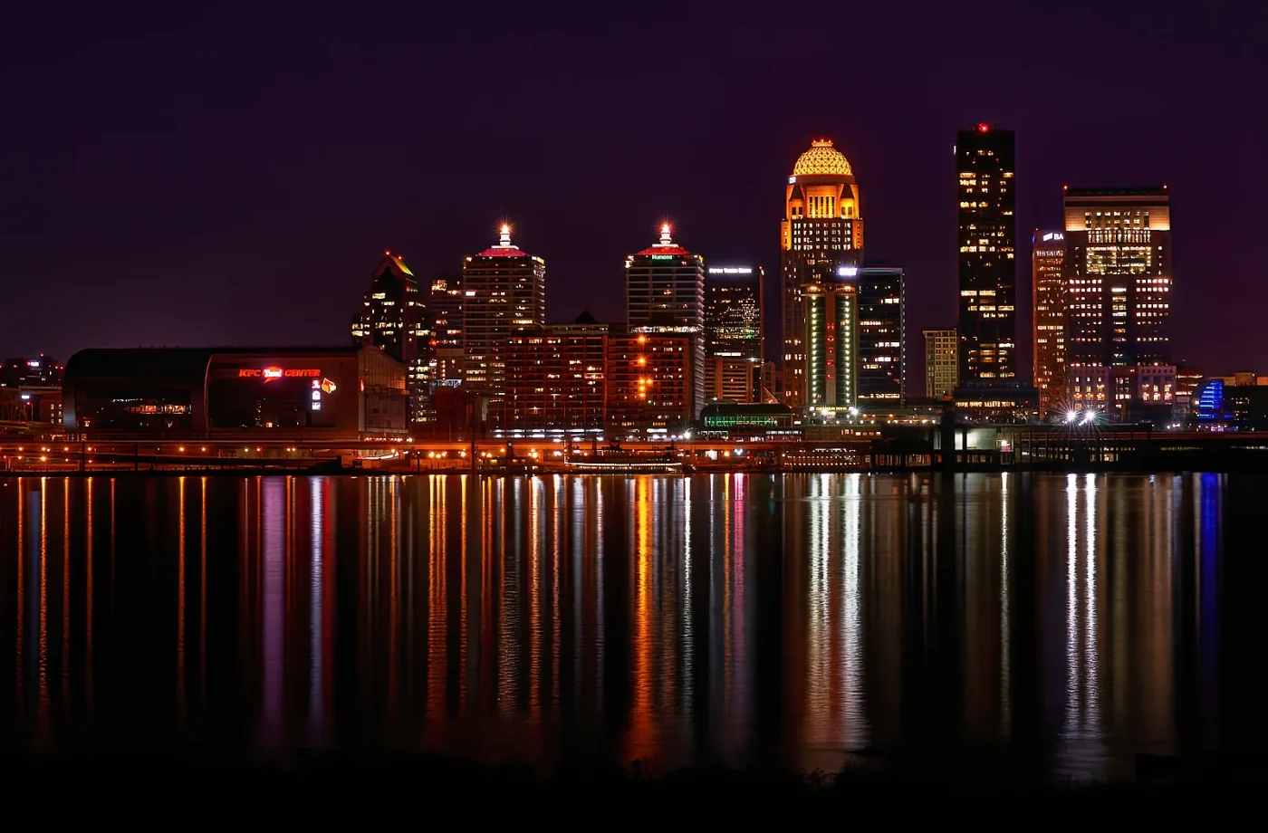 Louisville skyline illuminated beside the Ohio River at night