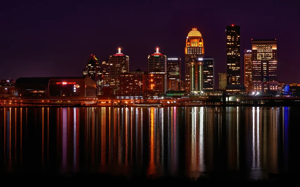 Louisville skyline illuminated beside the Ohio River at night