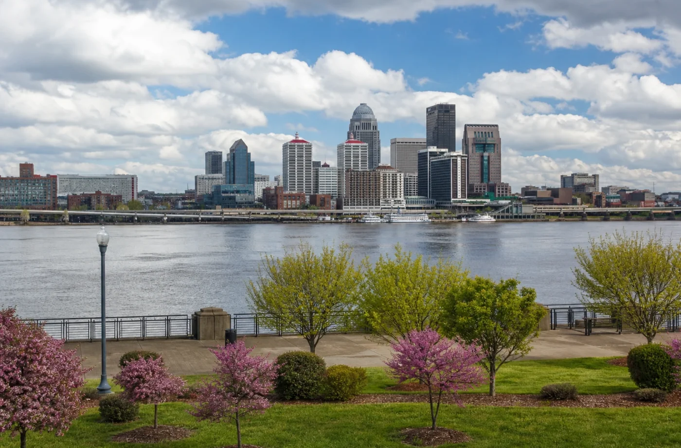 Downtown Louisville skyline beside the Ohio River on a spring day
