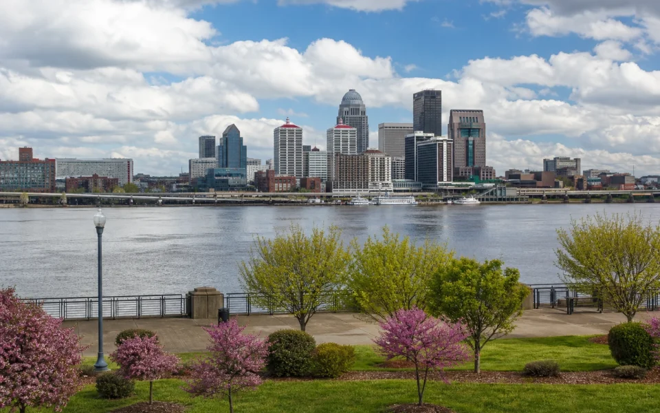 Downtown Louisville skyline beside the Ohio River on a spring day